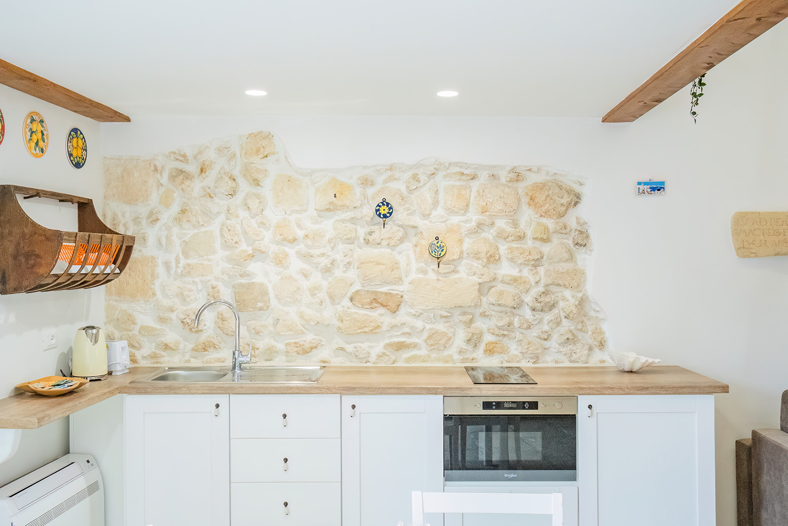 Angolo cucina con parete in pietra a vista